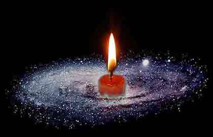 Artistic photo-collage of a lit red candle amidst a spiral galaxy by Wiesław Sadurski.